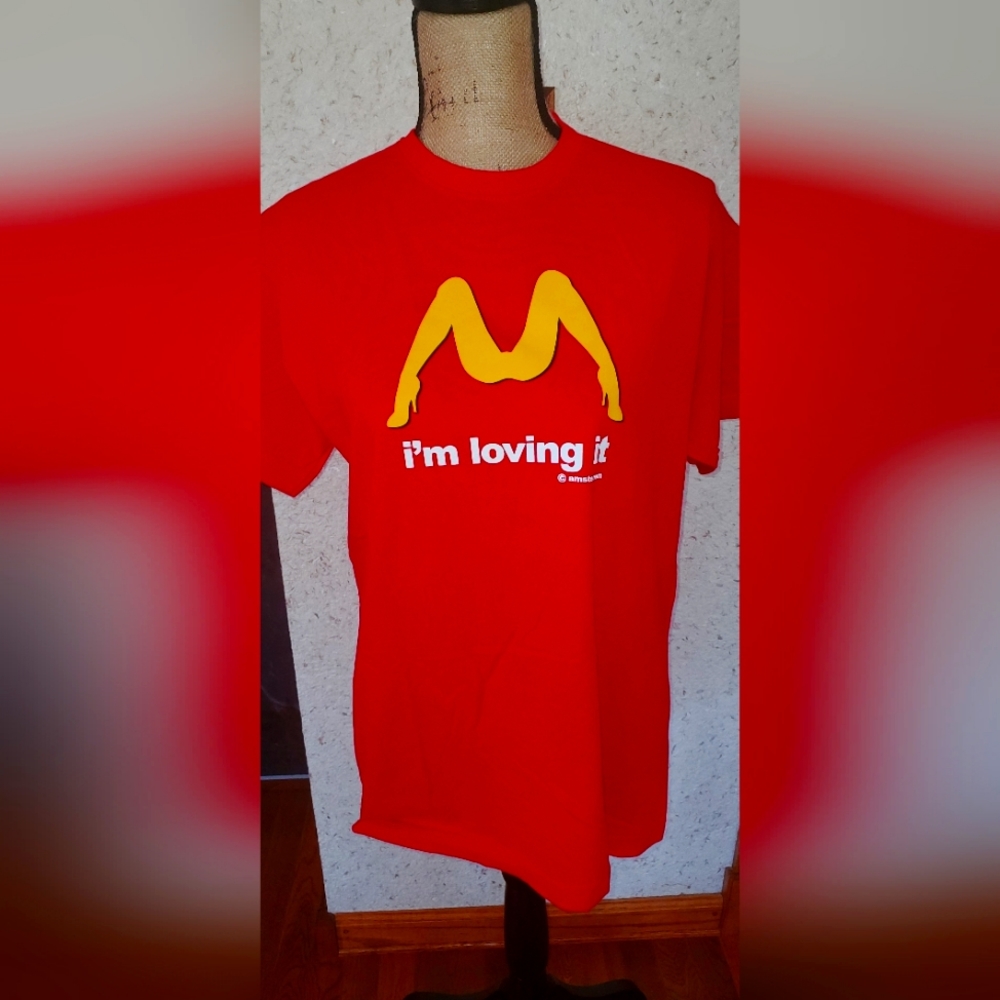Red shirt I'm loving it Amsterdam.  Size medium.